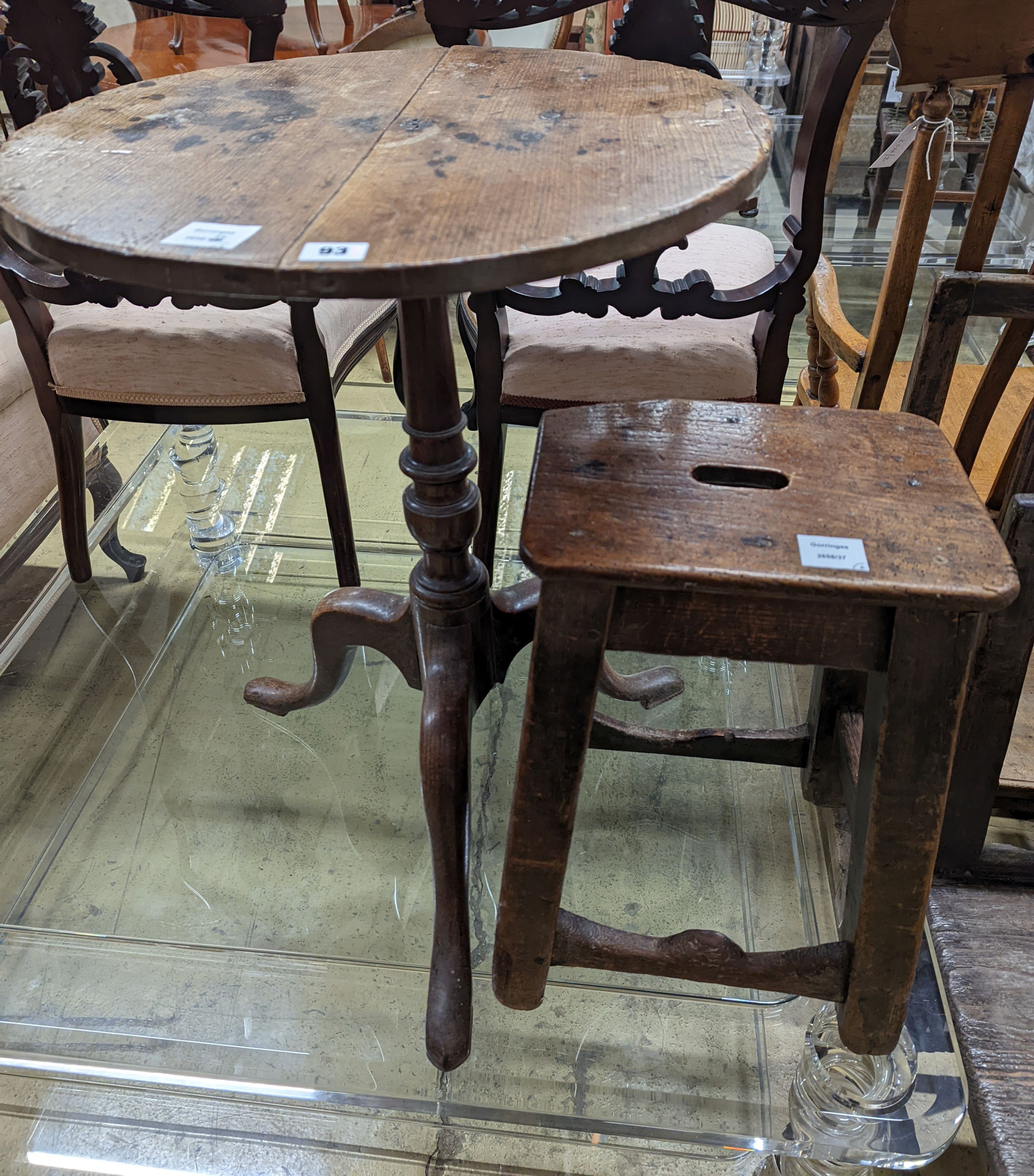A 19th century oak stool and an oak tripod table, table diameter 53cm, 70cm height